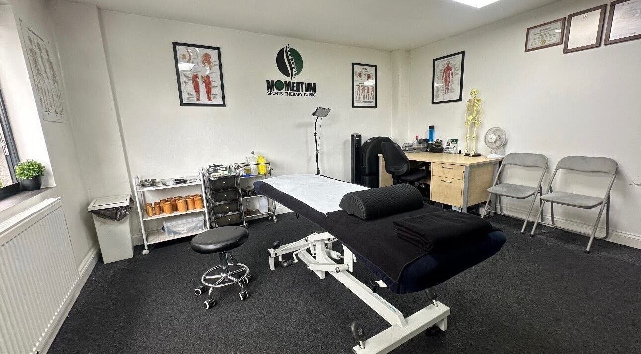 Massage therapy room at Momentum ST, Birmingham, England, GB, featuring a treatment table and anatomical decor.