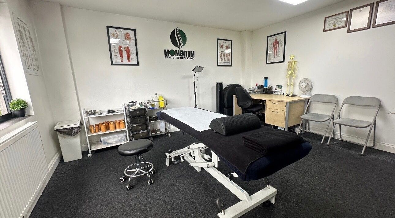 Massage therapy room at Momentum ST, Birmingham, England, GB, featuring a treatment table and anatomical decor.