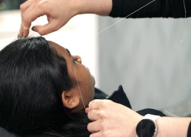 Threading service at Beauty Land and Aesthetics in Glasgow, Scotland, GB, enhancing a guest's appearance.