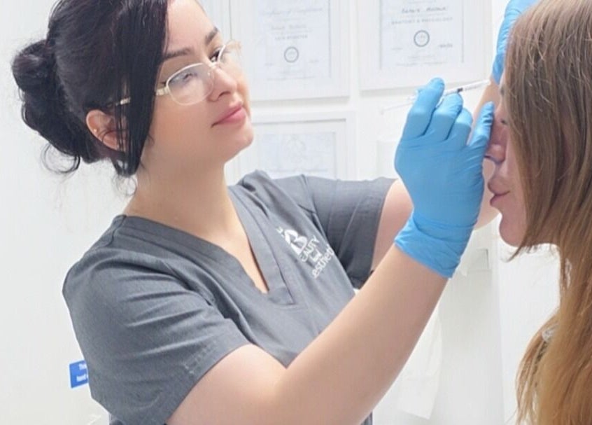 Expert providing detailed aesthetic treatment at Beauty Land and Aesthetics, Glasgow, Scotland, GB.