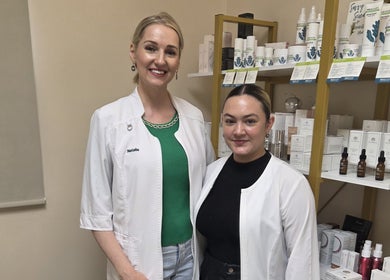 Friendly staff at Innersol Skincare in Fair Lawn, New Jersey, US, showcasing skincare products on shelves.