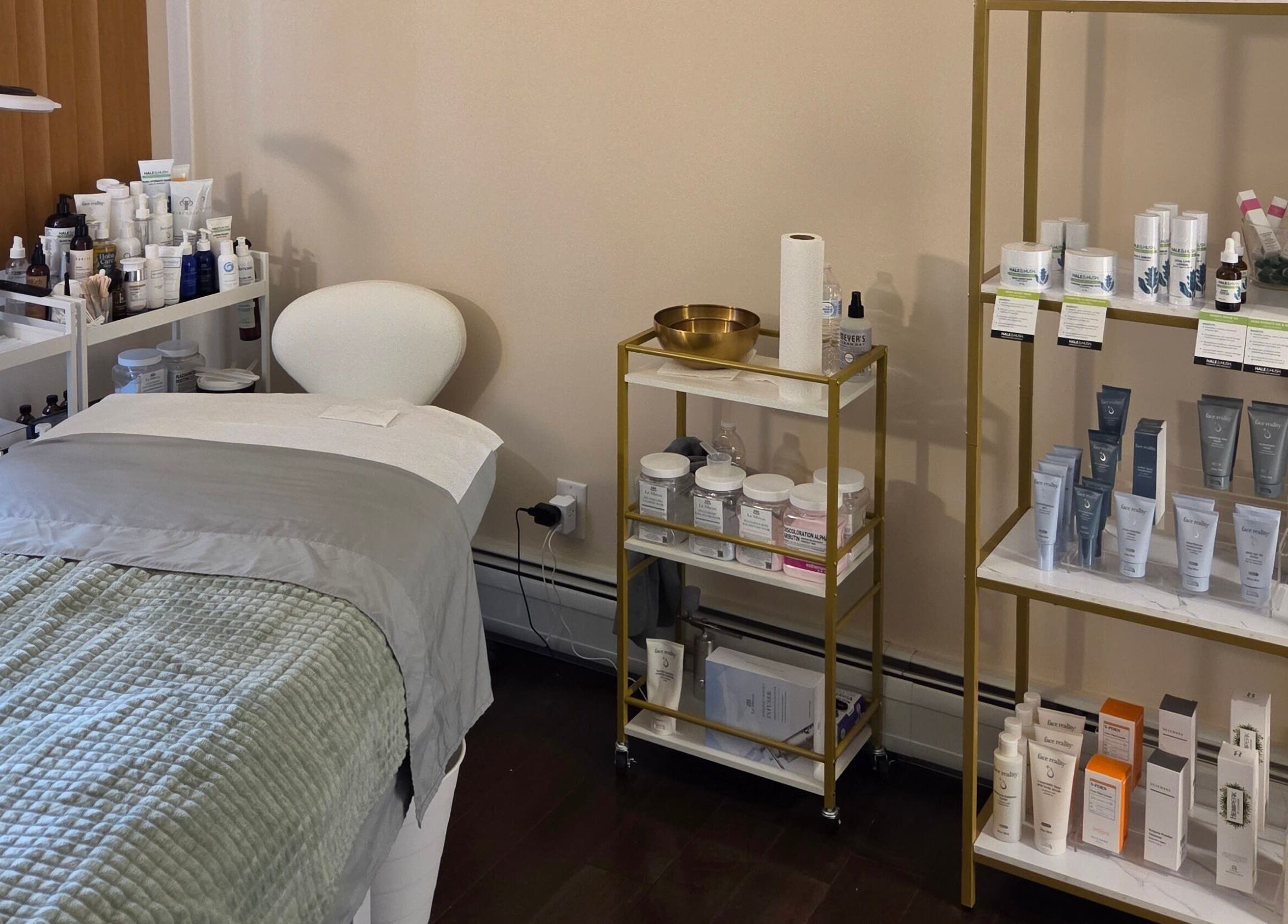 Innersol Skincare treatment room in Fair Lawn, New Jersey, US showcasing products and a cozy bed.