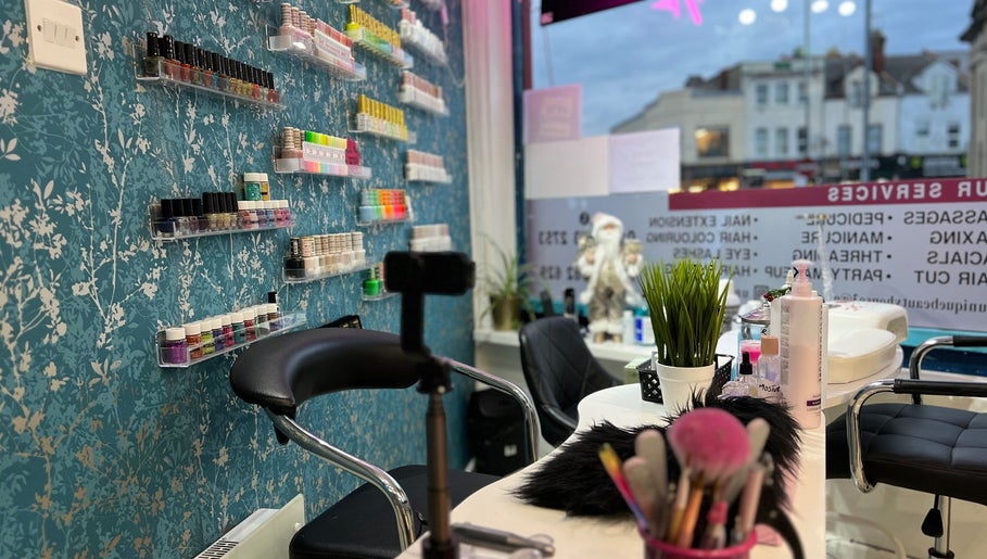 Nail station at Unique Beauty House, featuring colorful polish display in Reading, England, GB.