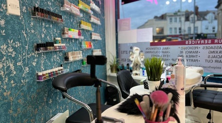 Nail station at Unique Beauty House, featuring colorful polish display in Reading, England, GB.