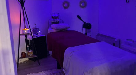 Tranquil treatment room at Unique Beauty House in Reading, England, GB, illuminated with soft, soothing lights.