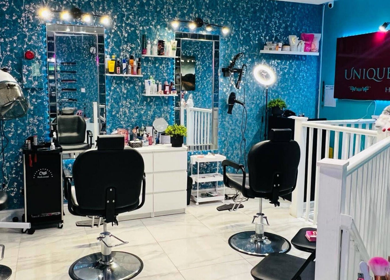Interior of Unique Beauty House in Reading, England, GB, featuring stylish hair styling stations and decor.