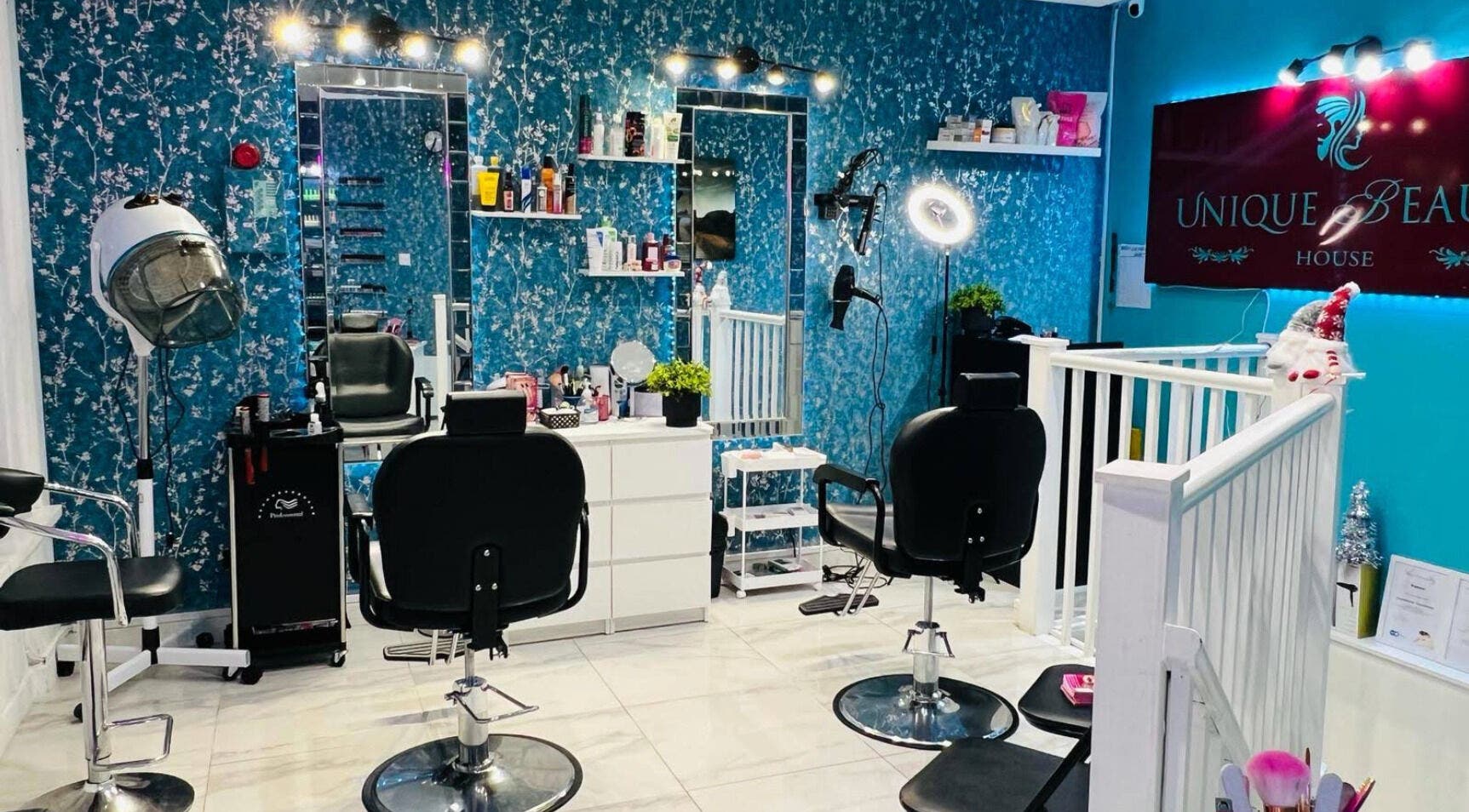 Interior of Unique Beauty House in Reading, England, GB, featuring stylish hair styling stations and decor.
