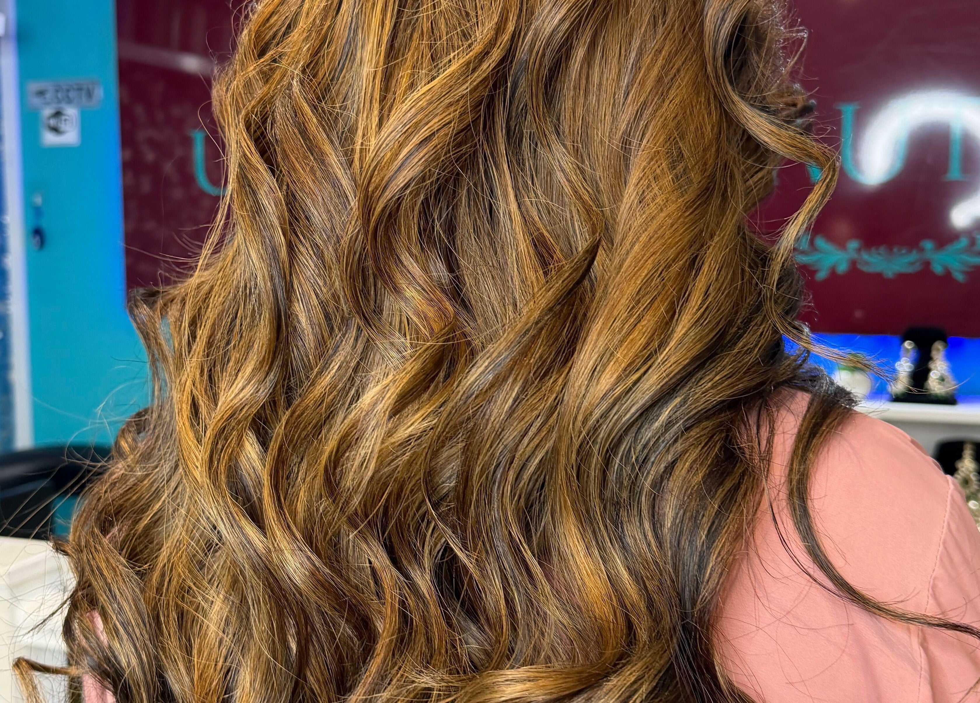Stylish golden brown curls at Unique Beauty House, Reading, England, GB showcase luxury hair service.