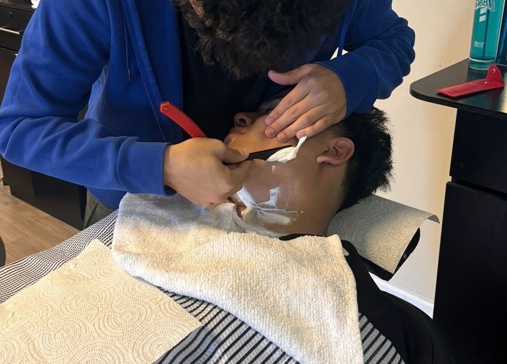 Close-up of a precision shave at Uncut Barber Academy in Savannah, Georgia, US.