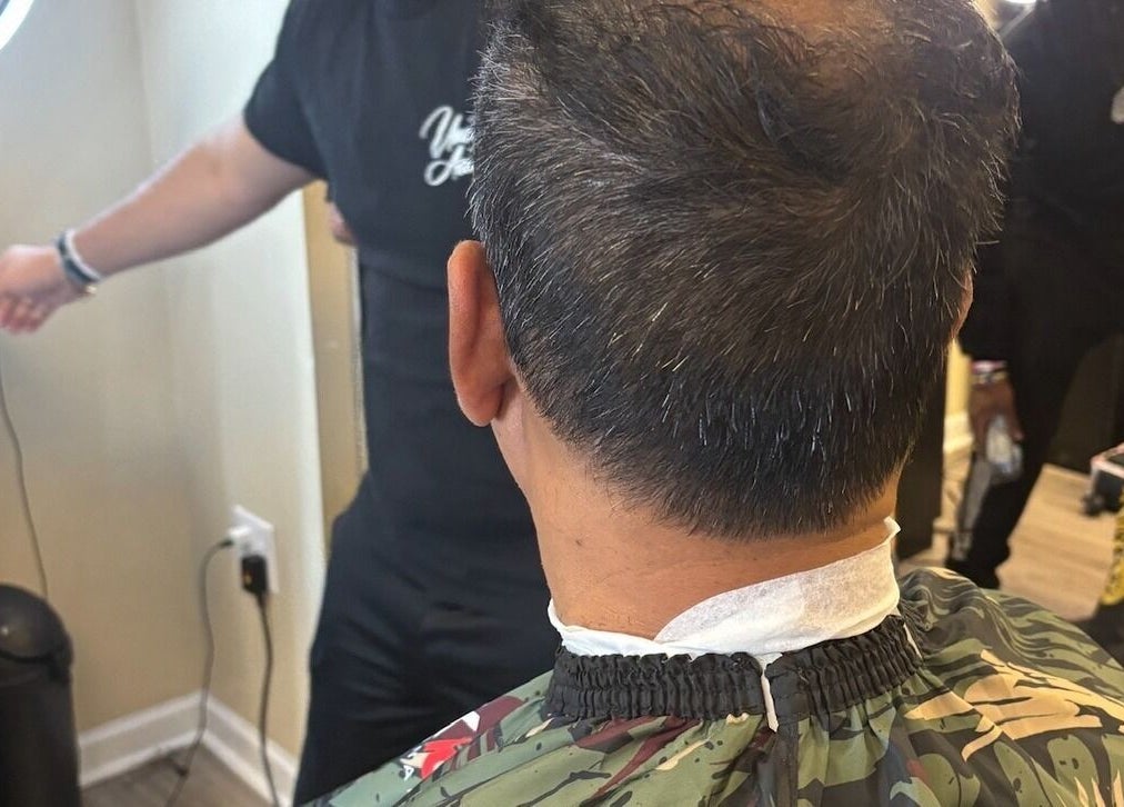 Haircut in progress at Uncut Barber Academy in Savannah, Georgia, US.