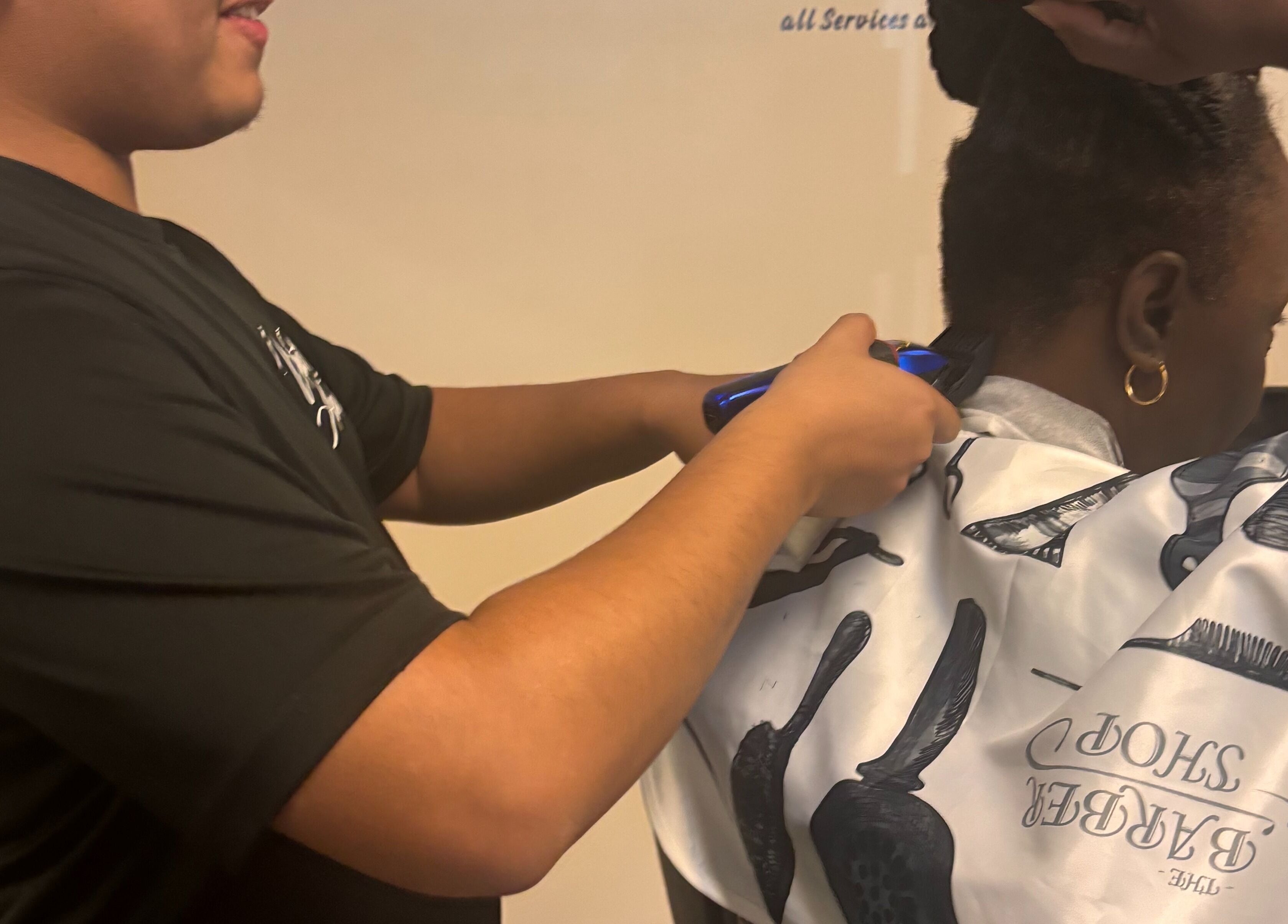 Barber styling hair at Uncut Barber Academy, Savannah, Georgia, US.