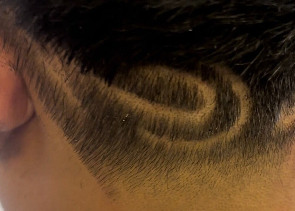 Detailed undercut design at Uncut Barber Academy in Savannah, Georgia, US, showcasing skilled barber artistry.