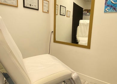 Treatment room at Dr. Ina Zhou's clinic in Coquitlam, British Columbia, CA with a comfortable chair and mirror.