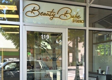 Beauty Studio entrance in Delta, British Columbia, CA with glass doors and product display.