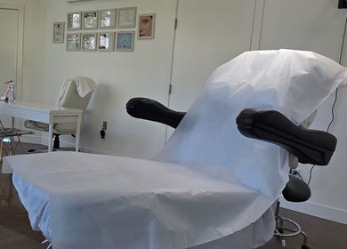 Calm treatment room at Beauty Studio in Delta, British Columbia, CA, featuring a comfortable chair and certificates.