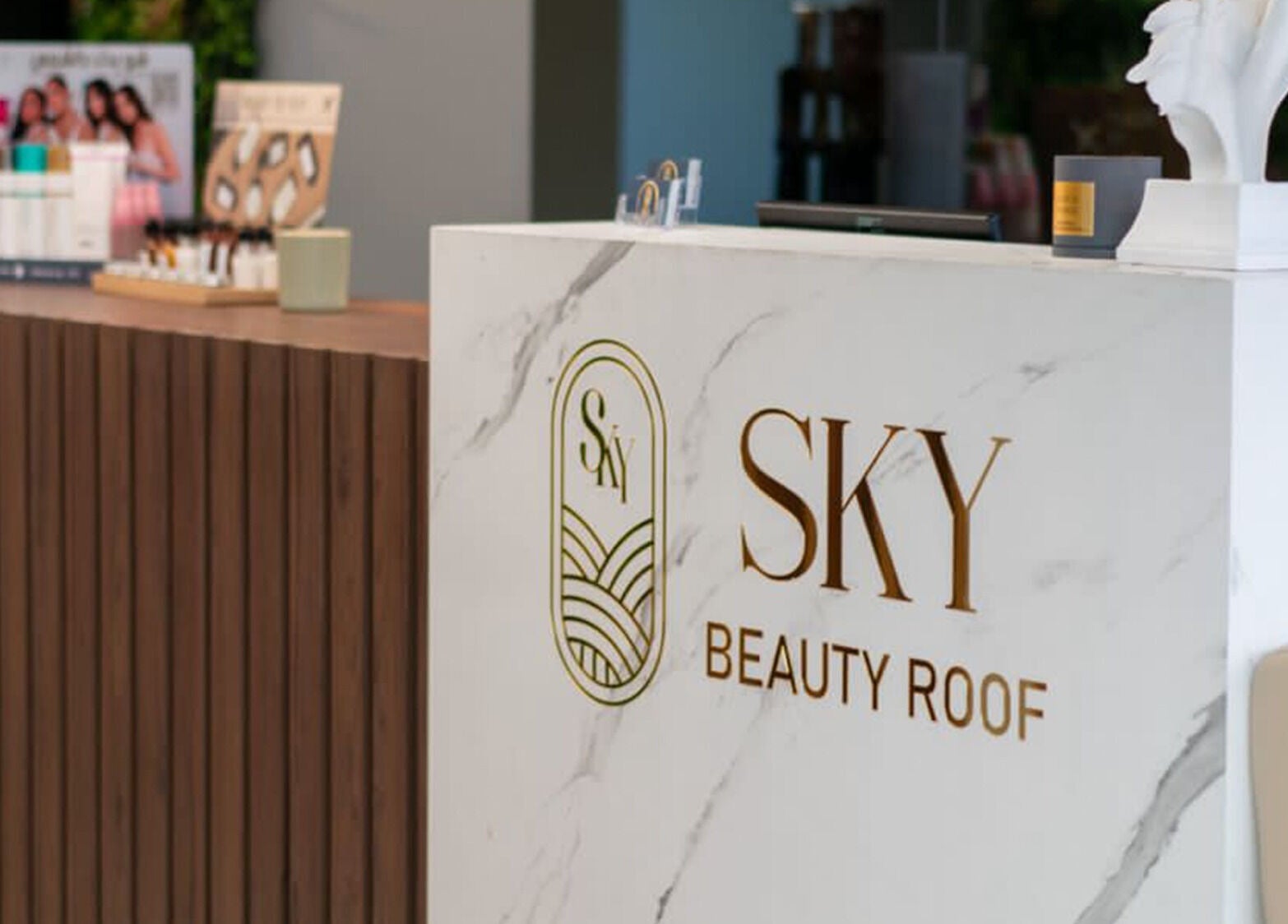 Reception desk at Sky Beauty Roof, Amman, JO with elegant branding and decor.