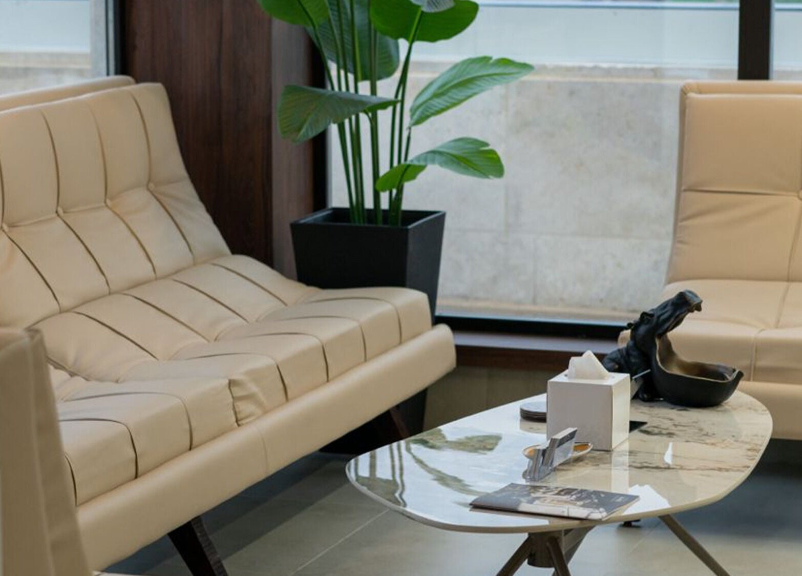 Relaxing lounge area at Sky Beauty Roof, Amman, JO with beige sofas and modern decor.
