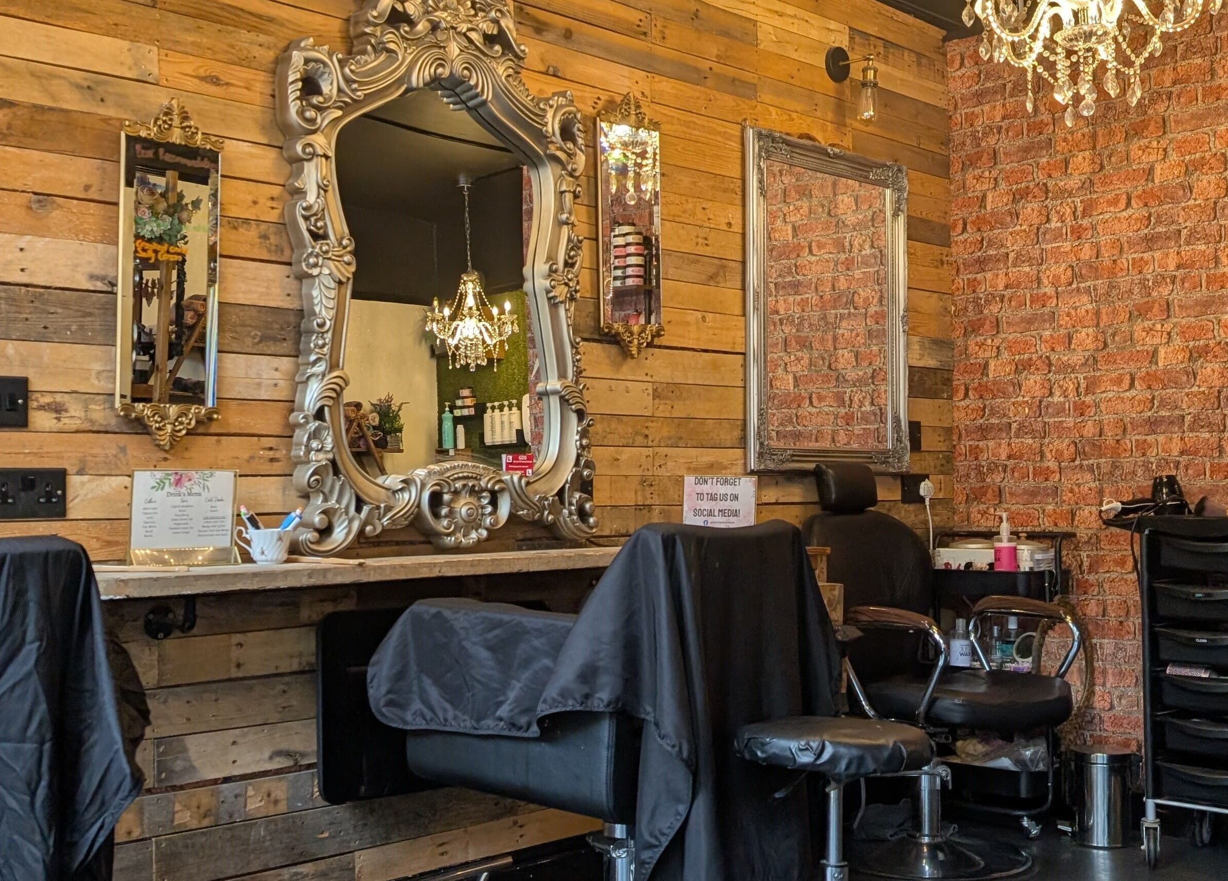 Elegant salon interior at Rock Paper Scissors Hair & Beauty Salon, Walmer, England, GB with ornate mirrors and chandeliers.