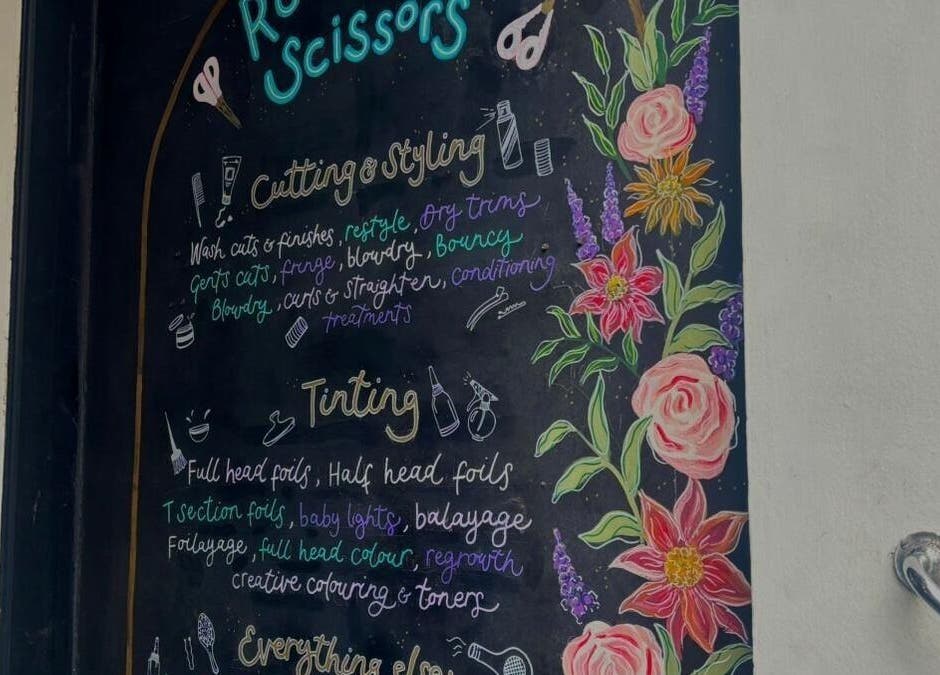Chalkboard menu with flowers at Rock Paper Scissors Hair & Beauty Salon, Walmer, England, GB.