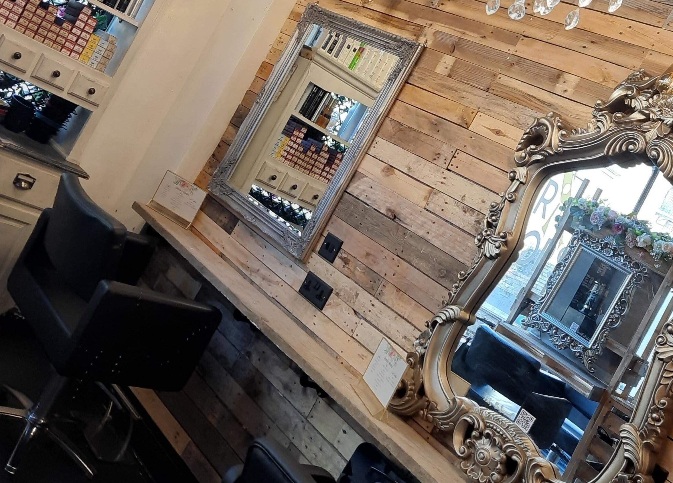 Elegant styling area at Rock Paper Scissors Hair & Beauty Salon, Walmer, England, GB with ornate mirrors and plush chairs.