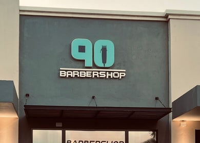 Front facade of Barbershop90 in Willemstad, Curaçao, CW, showcasing its stylish logo and modern exterior.