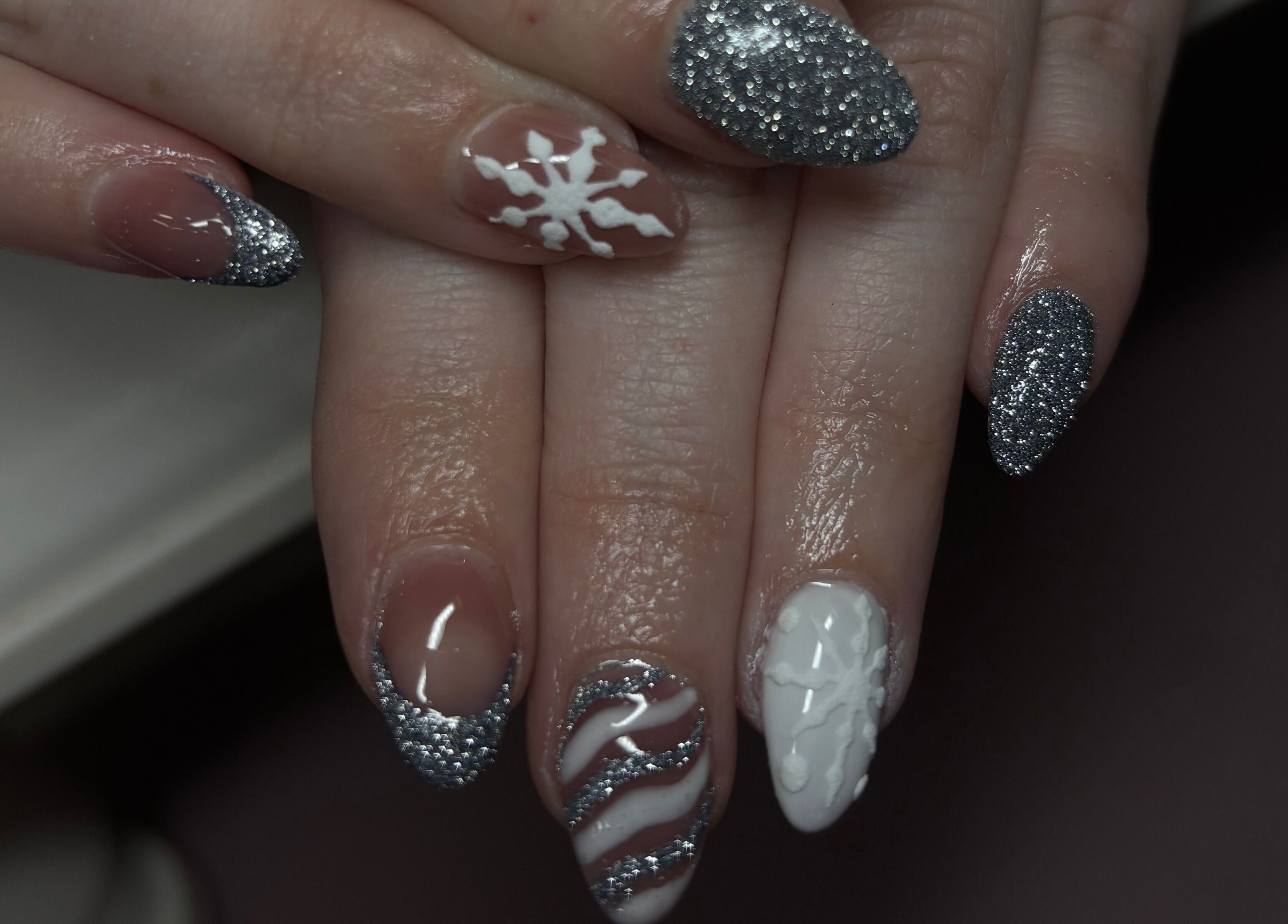 Silver and white nail art at Gwen’s Aesthetics, Pembroke, Ontario, CA, featuring snowflake designs.