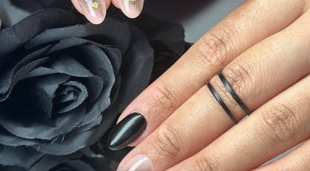 Chic nail art at Cillah Nails, Cape Town with black and clear design adorned with gold flakes.