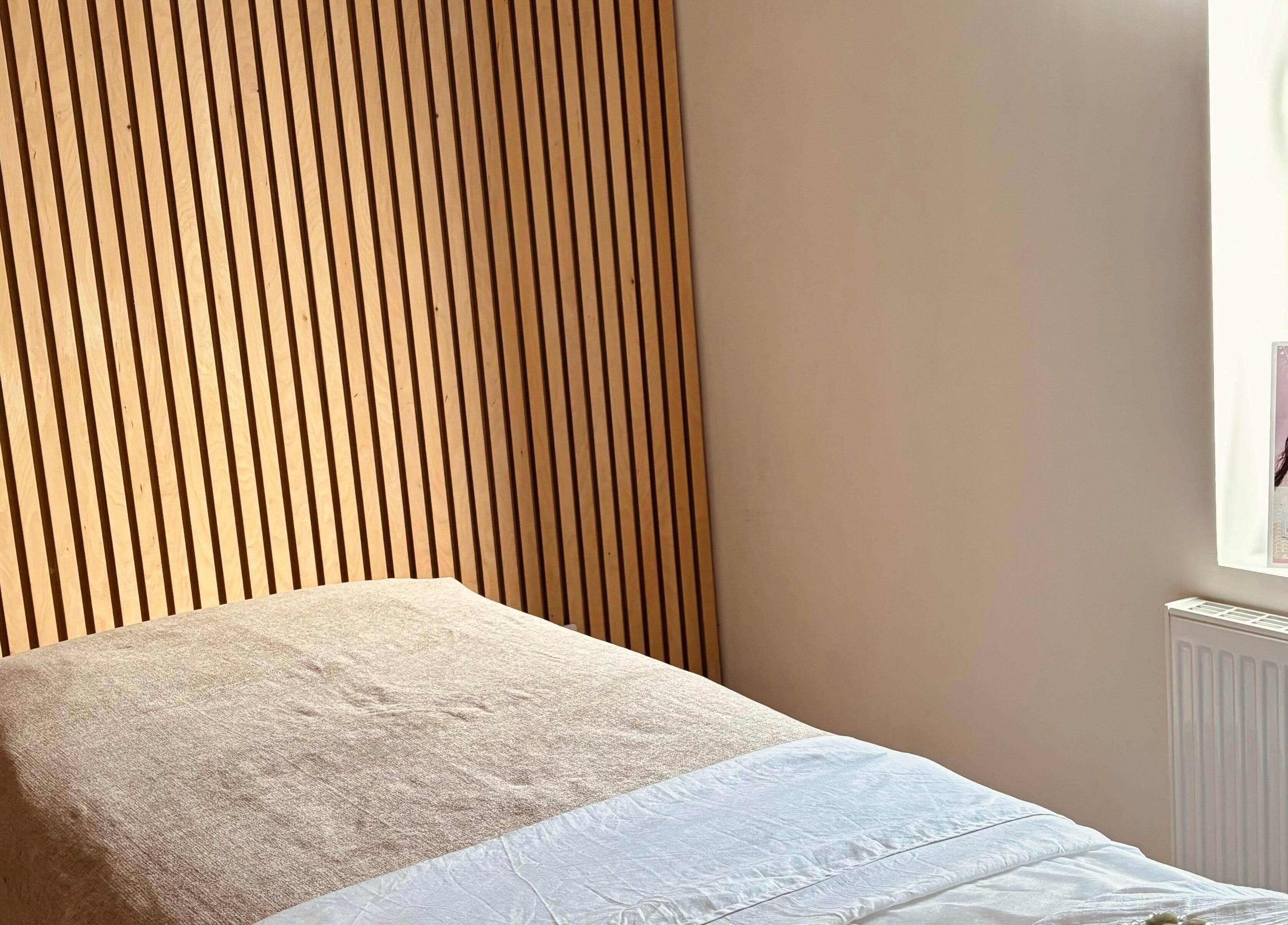 Calming treatment room at Adeline Peillet at East of Eden - Walthamstow E17, London, England, GB with wooden wall.