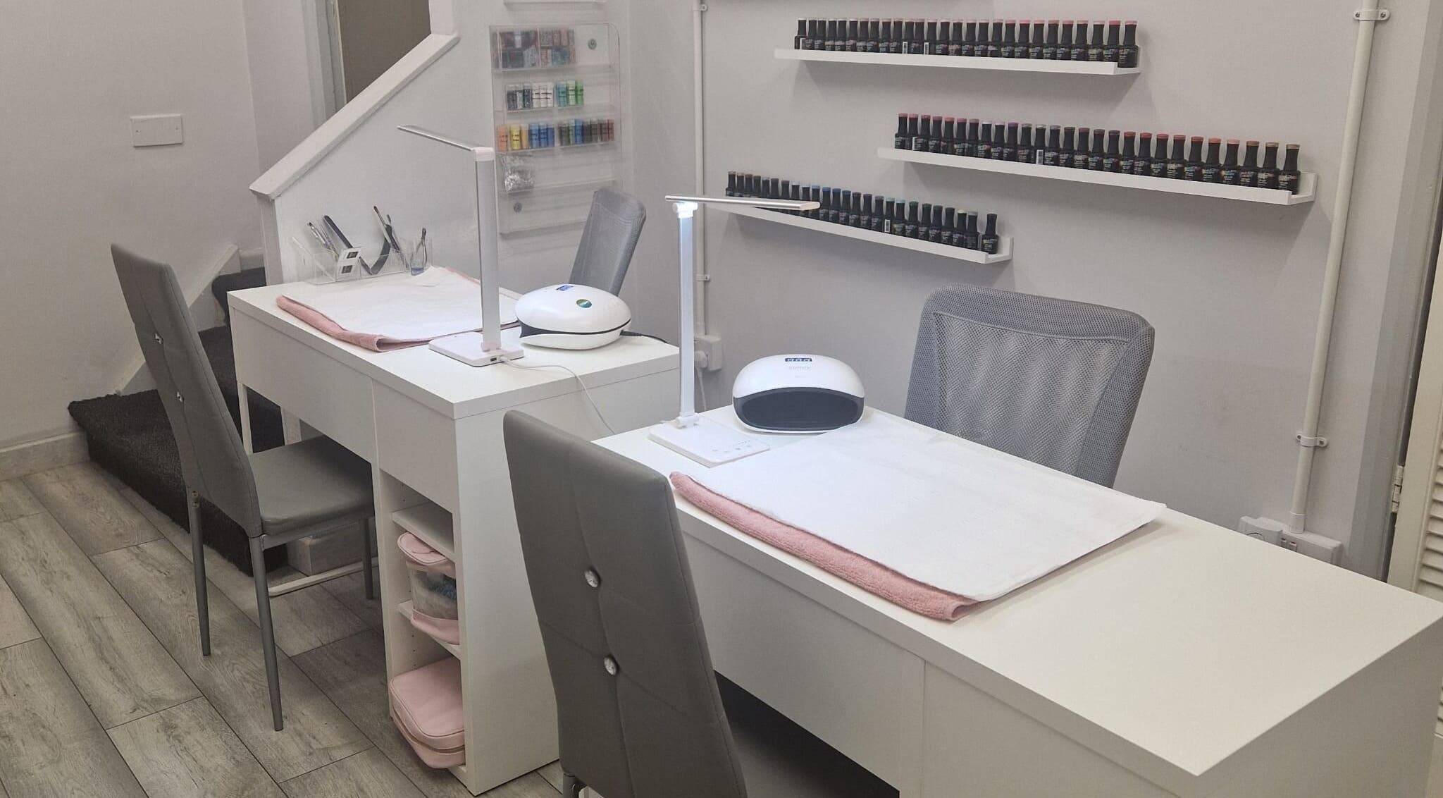 Modern nail station at Coco Luxe Beautique in Stoke-on-Trent, England, GB showcasing sleek design and organized nail polishes.