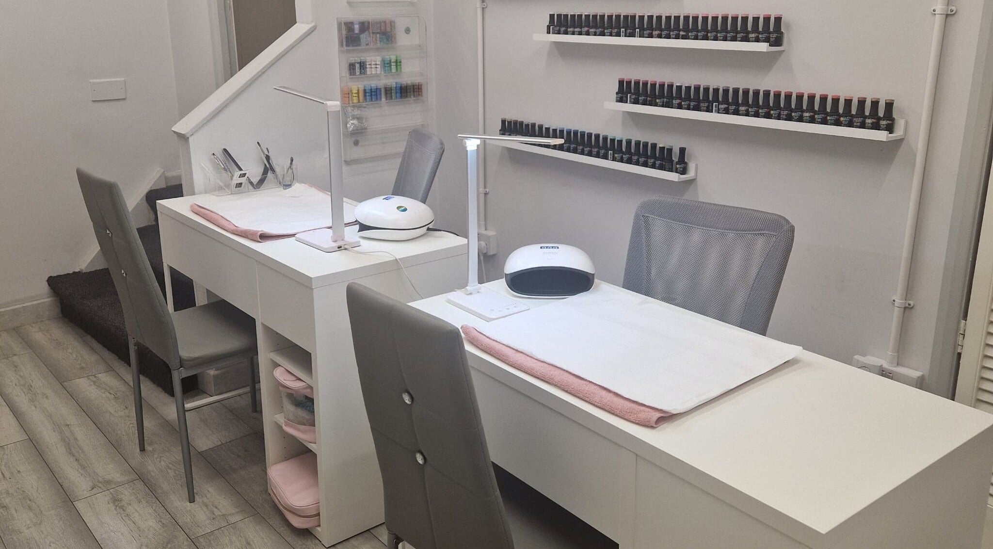 Modern nail station at Coco Luxe Beautique in Stoke-on-Trent, England, GB showcasing sleek design and organized nail polishes.