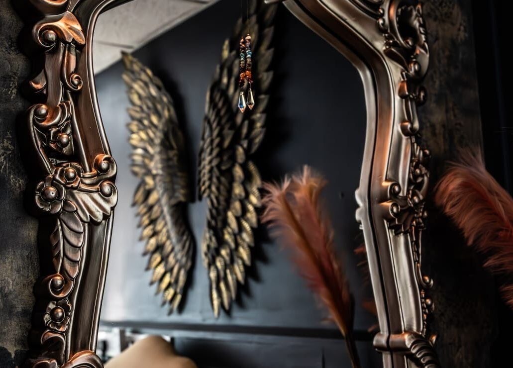 Ornate mirror with feather decor at The Edgy Therapist @ The Holistic Hideaway, Broadclyst, England, GB.