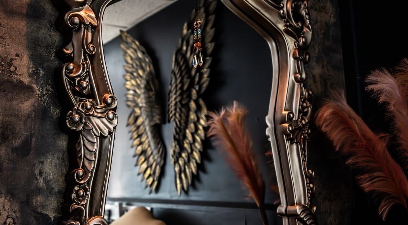 Ornate mirror with feather decor at The Edgy Therapist @ The Holistic Hideaway, Broadclyst, England, GB.