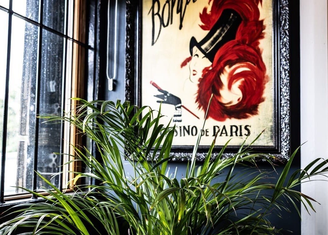 Elegant interior of The Edgy Therapist @ The Holistic Hideaway, Broadclyst, England, with vintage art and lush plants.