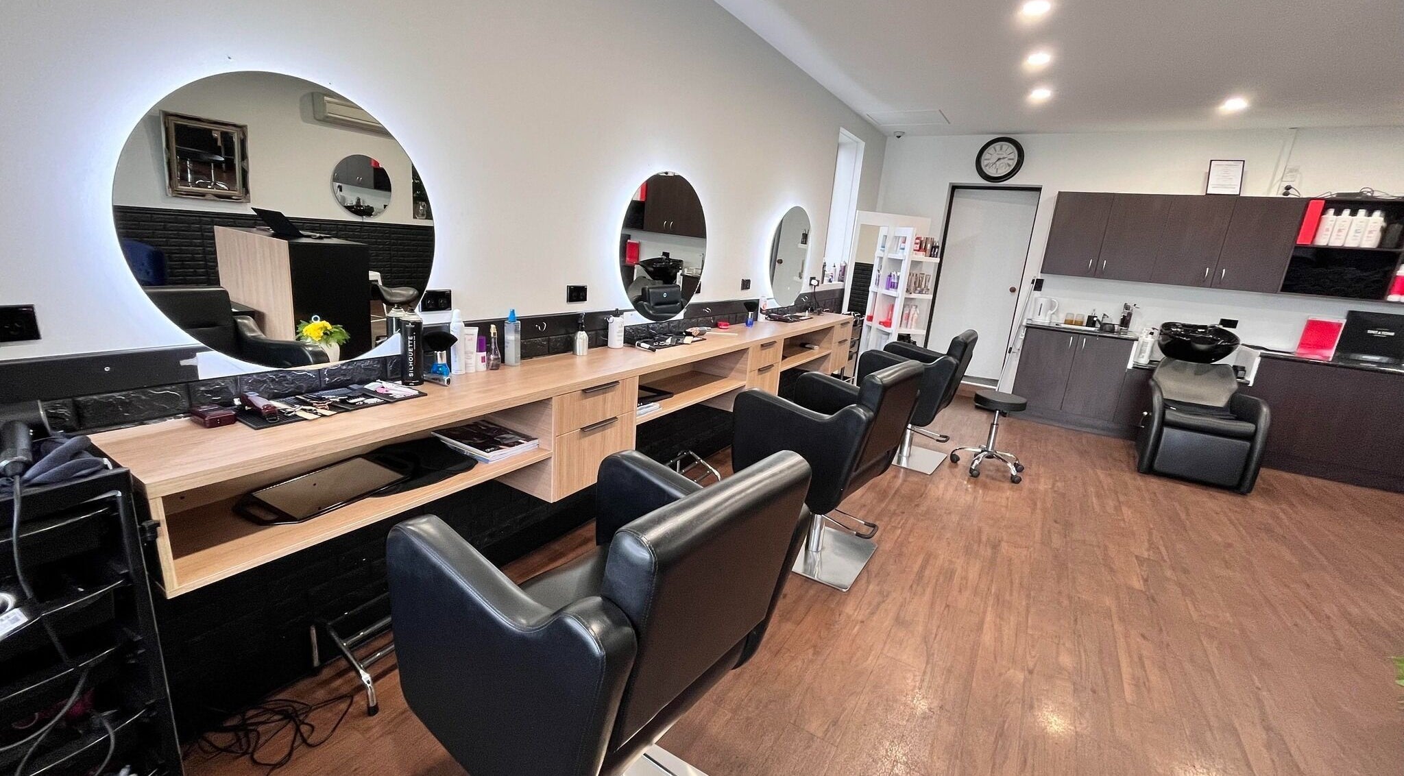 Modern interior of Divine Hair and Beauty Salon & Barbers, Christchurch, Canterbury, NZ, featuring styling stations.