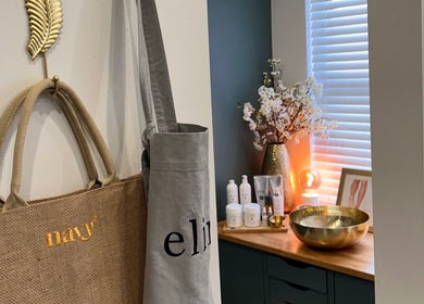 Chic interior of Pure Nails by Rachel in Newtown, Wales with decor and beauty products on display.