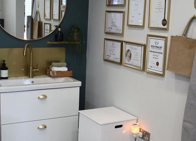 Chic interior of Pure Nails by Rachel, Newtown, Wales featuring a vanity and framed awards.