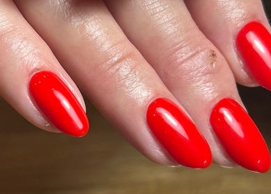 Close-up of vibrant red nails at Pure Nails by Rachel, Newtown, Wales, GB, showcasing expert manicure.