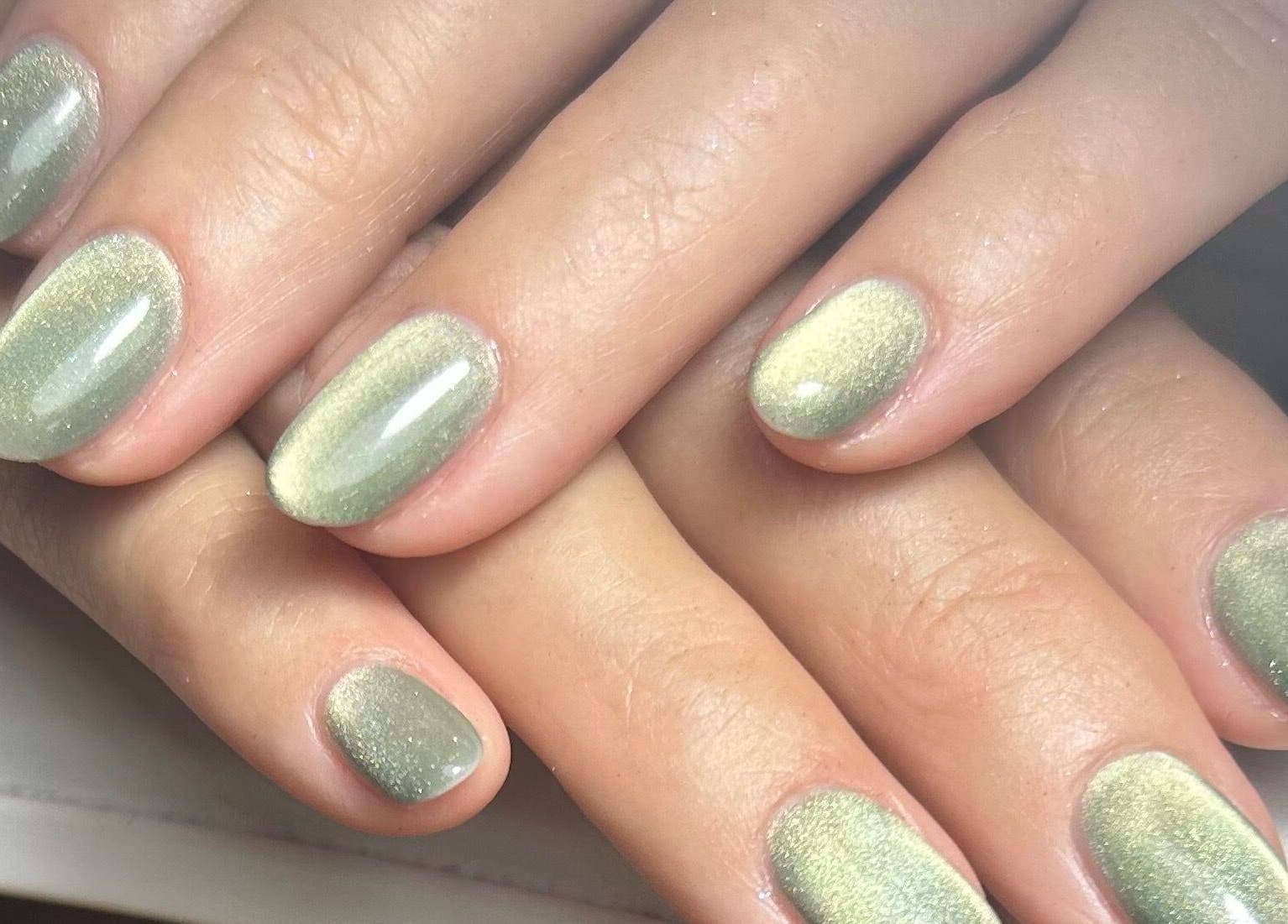 Metallic mint green manicure at Pure Nails by Rachel, Newtown, Wales, GB showcasing elegant nail art.