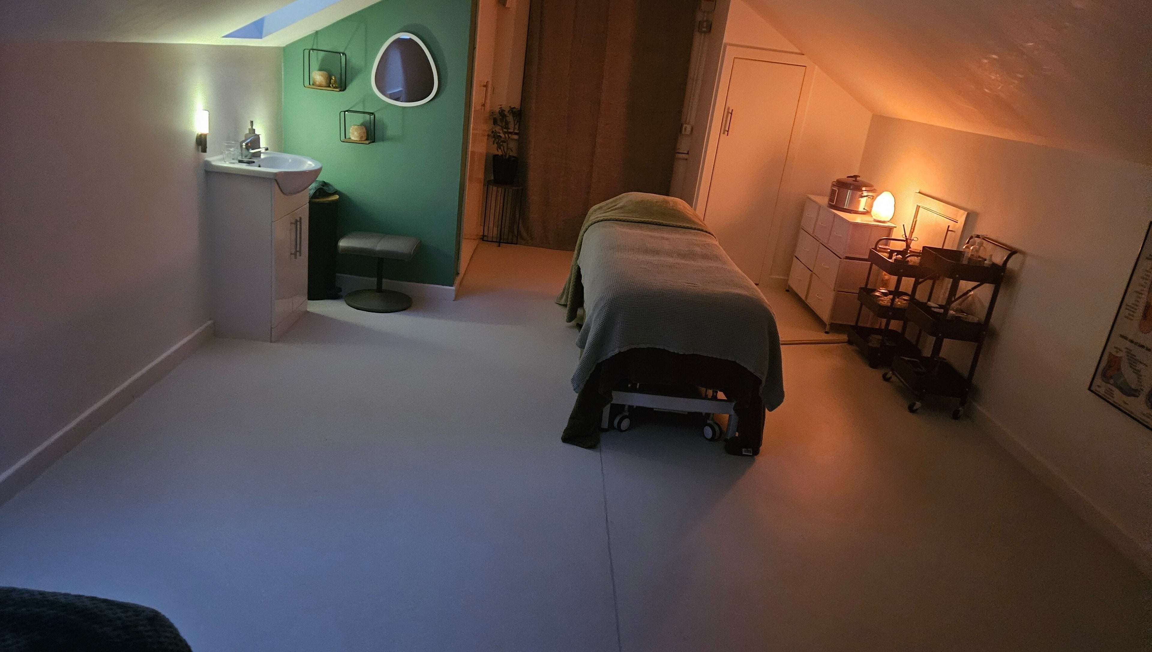 Relaxing therapy room at Eivissa Wellbeing, Lancaster, England, GB with a massage bed and gentle lighting.
