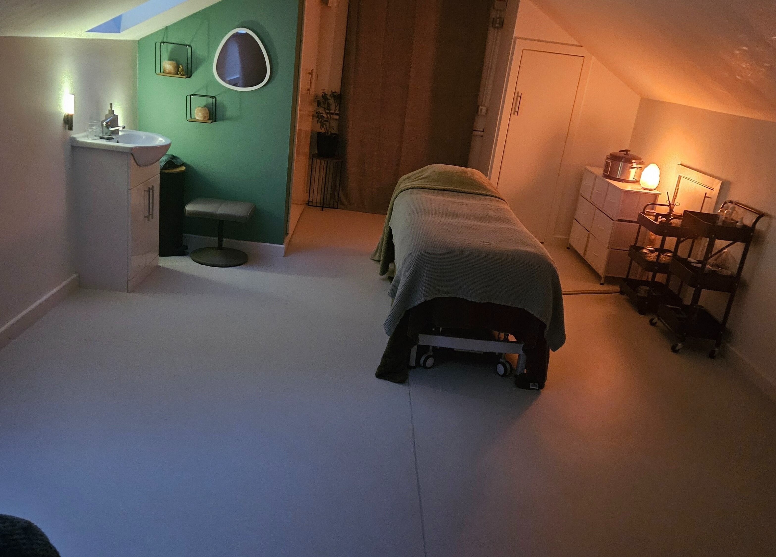 Relaxing therapy room at Eivissa Wellbeing, Lancaster, England, GB with a massage bed and gentle lighting.