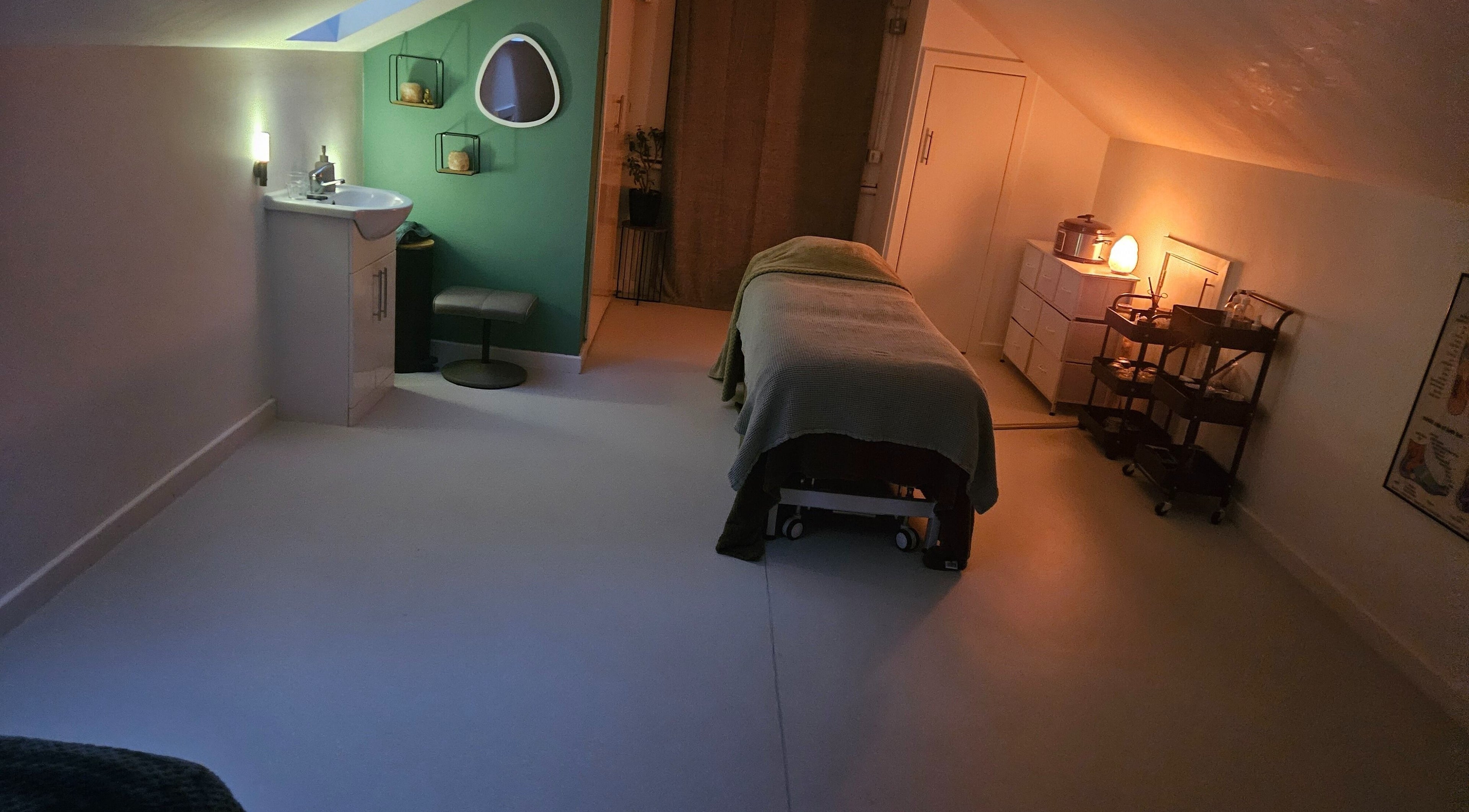 Relaxing therapy room at Eivissa Wellbeing, Lancaster, England, GB with a massage bed and gentle lighting.