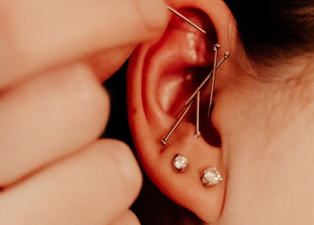 Close-up of ear piercings at Eivissa Wellbeing, Lancaster, England, GB highlighting detailed jewelry.