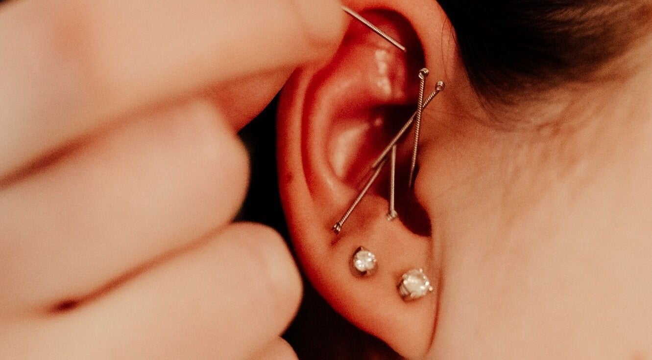 Close-up of ear piercings at Eivissa Wellbeing, Lancaster, England, GB highlighting detailed jewelry.