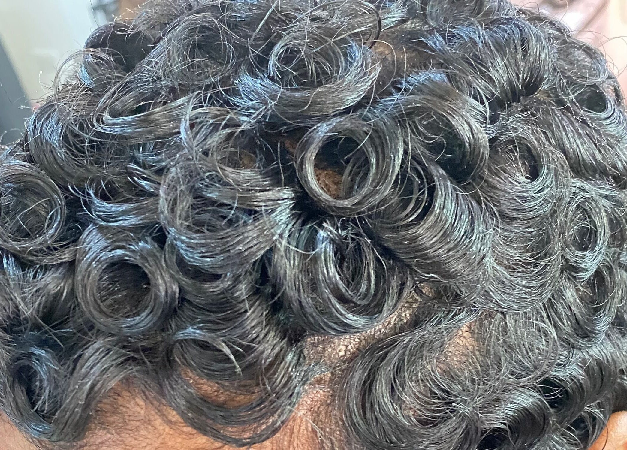 Close-up of stylish curls at Haus Of Lisa J, Bridgetown, Saint Michael, BB.