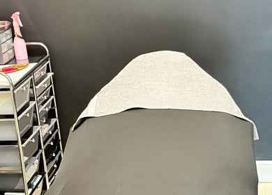 Relaxing treatment bed at AB Beauty, Newton Abbot, England, GB, surrounded by professional spa supplies.