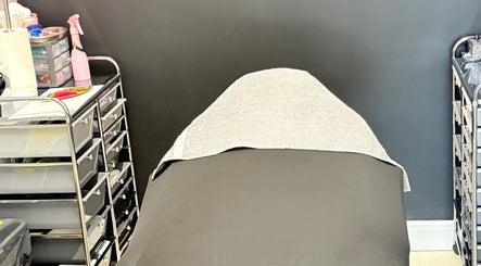 Relaxing treatment bed at AB Beauty, Newton Abbot, England, GB, surrounded by professional spa supplies.