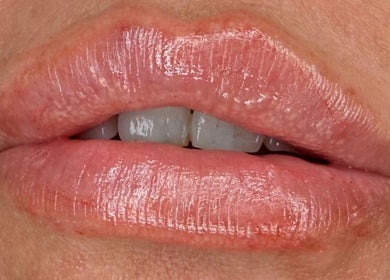 Closeup of glossy lips at AB Beauty, Newton Abbot, England, GB, showcasing perfect lip care.
