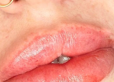 Close-up of glossy lips showcasing beauty treatment at AB Beauty, Newton Abbot, England, GB.