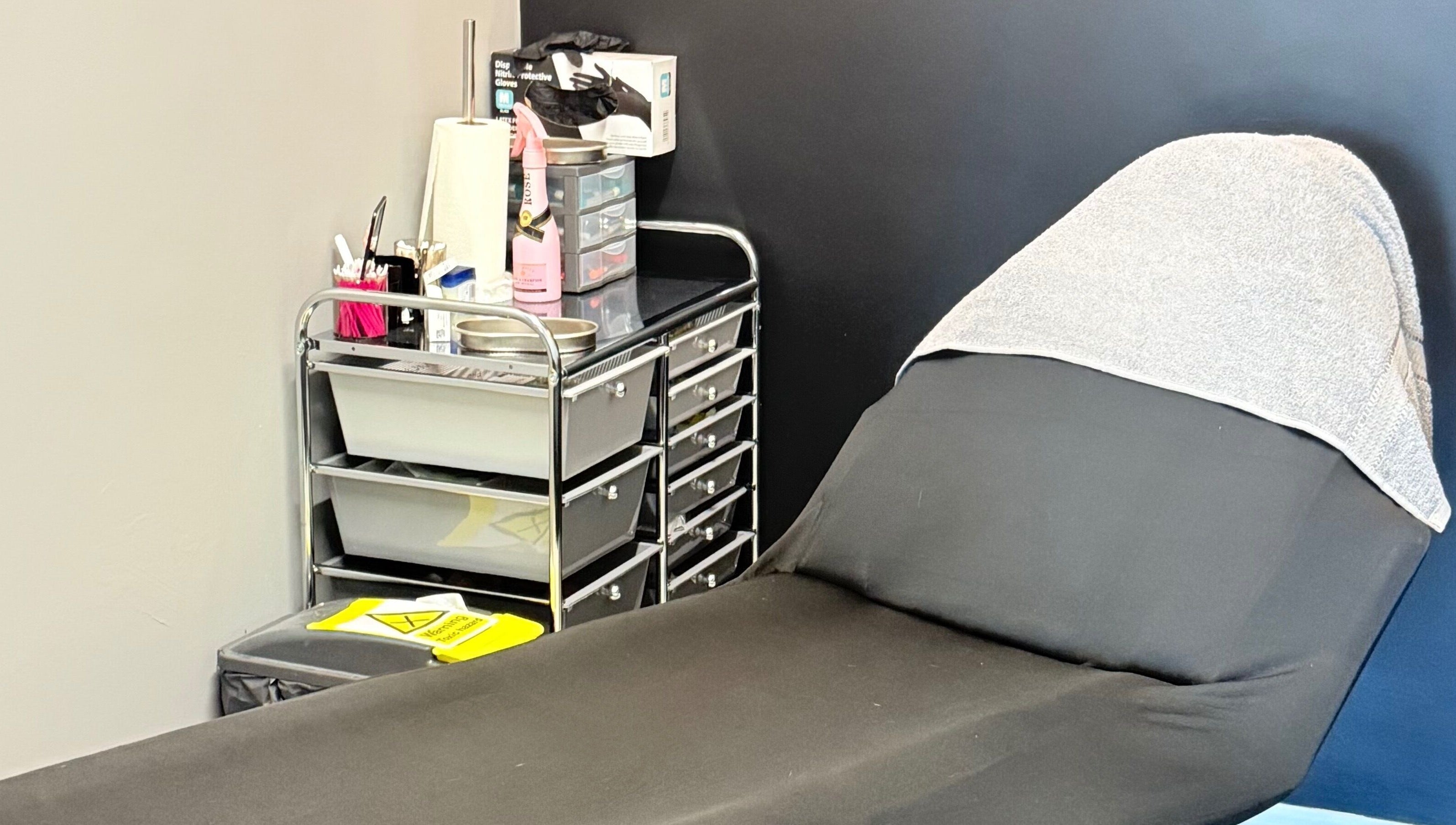 Comfortable treatment bed in serene AB Beauty, Newton Abbot, England, GB, ready for clients.