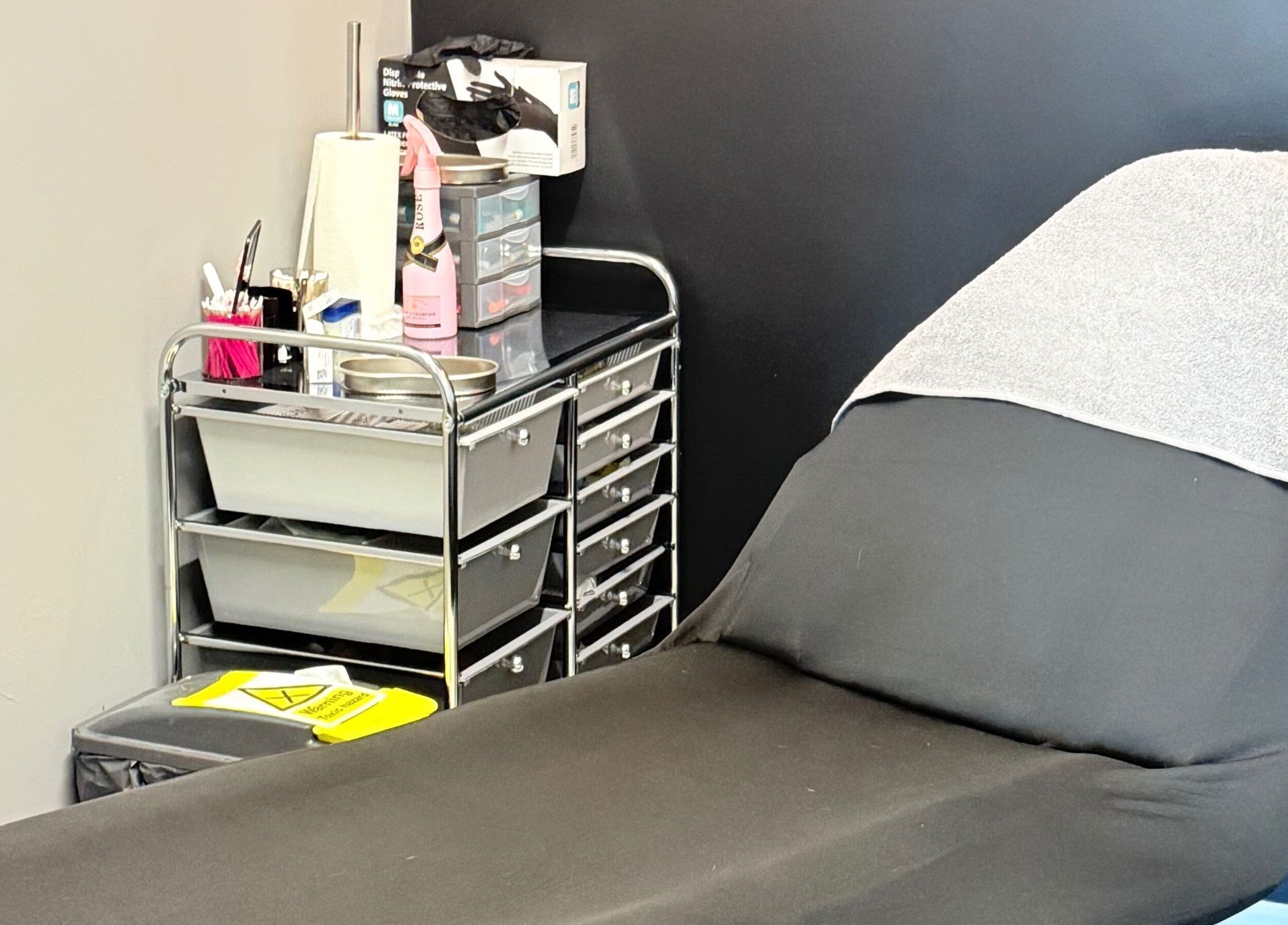 Comfortable treatment bed in serene AB Beauty, Newton Abbot, England, GB, ready for clients.